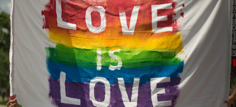 Pride flag on which love is love is written