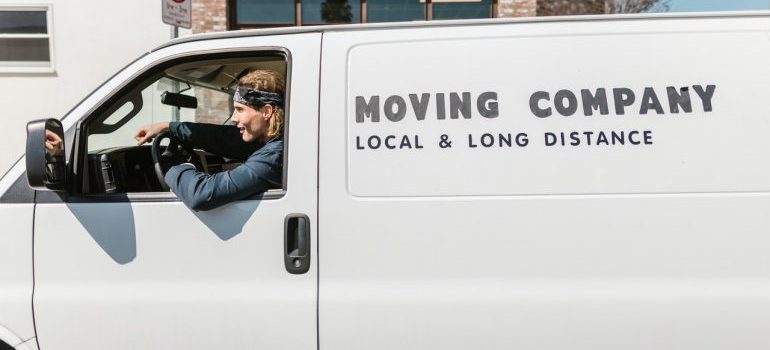 Man sitting in a moving van to ready to tell you about mistakes to avoid when moving to San Antonio