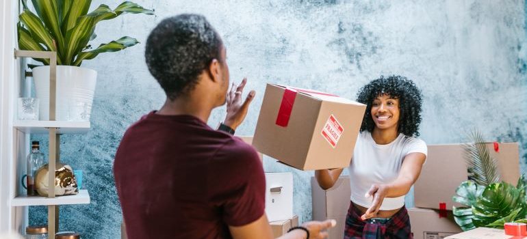 man and woman tossing a box before moving from Texas to another state