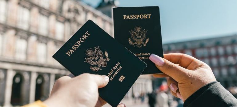 two people holding their passports