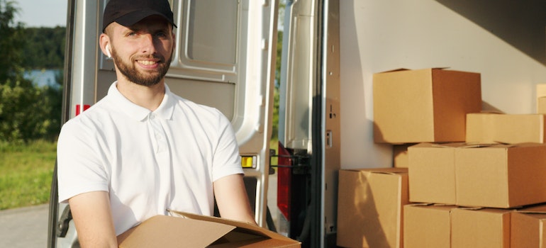 Man packing boxes before moving to Gaithersburg from Dallas