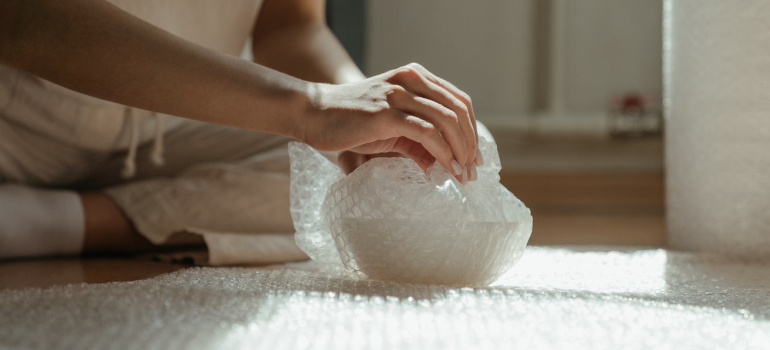 a person packing a vase