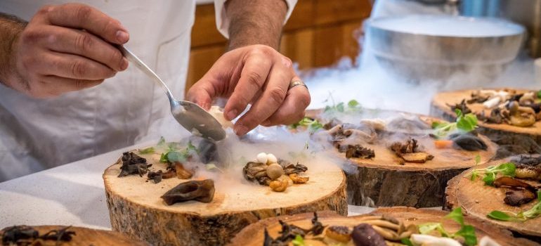 Man preparing food in restaurant after moving to Naples FL