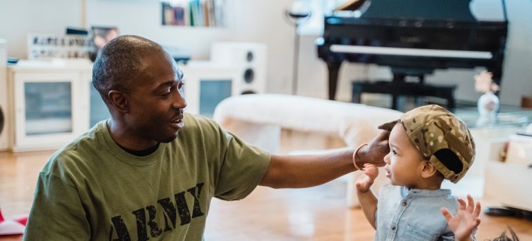 Man with Army shirt playing with his son