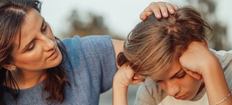 Woman talking to her son, because talking to a kid can make sure your teenager likes moving from Dayton 