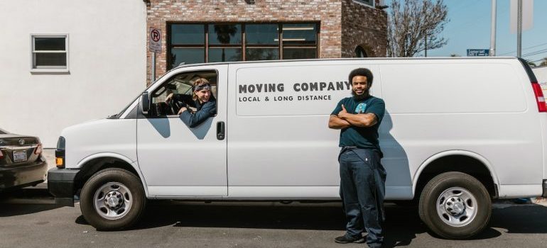 Professional moving company van and workers