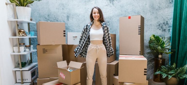 Girl with boxes knows some tips on enjoying your Miami relocation
