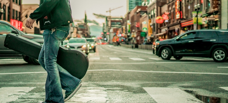 An artist walking down the street after moving from Texas to Nashville. 