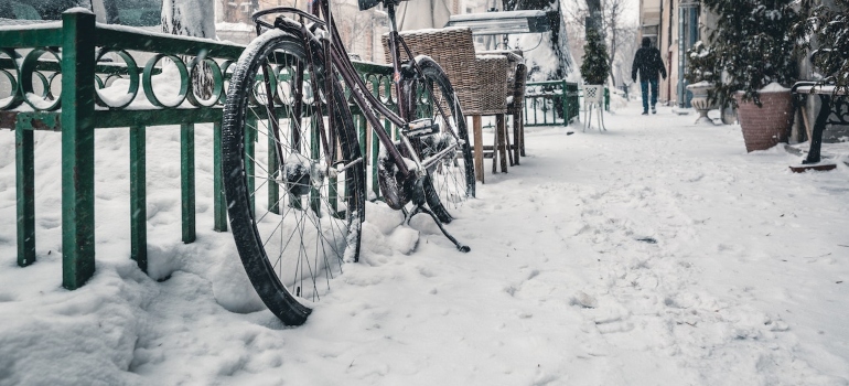 A bicycle out in the snow