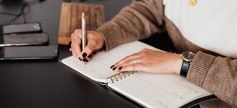 woman taking notes before moving from Dallas to Miami