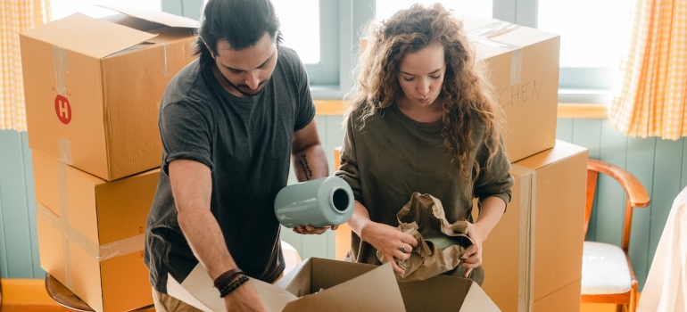 A man and woman are packing for moving to Bastrop TX