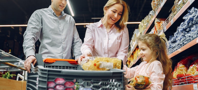 A family shopping for groceries together after they've relocated to Columbus