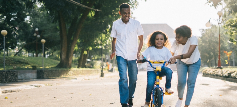 a family in the park thinking about the reasons to move to Converse TX in 2023