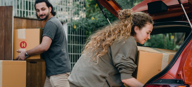 Couple taking things out of the car before moving your car across the country