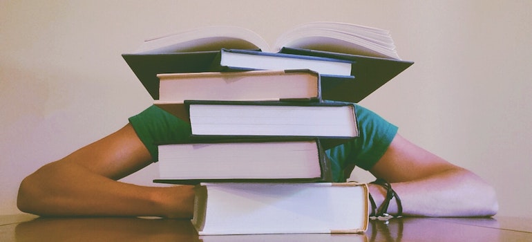 person with books thinking how to adjust to life in Raleigh NC