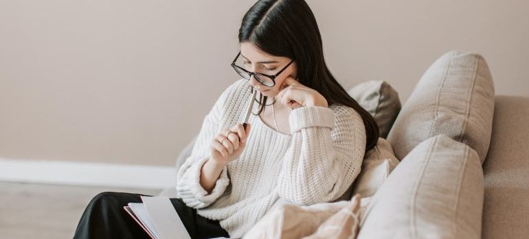 a woman reading about things to know about big US cities to move to in 2023