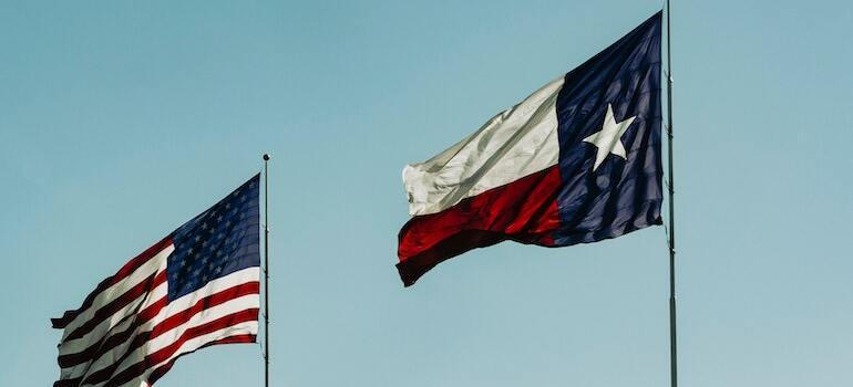 The Amercian and Texan flag in the wind 