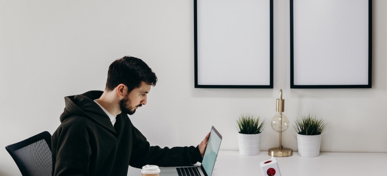 a man searching on his laptop how to spend time after moving to Sugar Land 