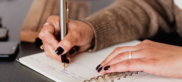 A woman writing down notes in diary before leaving Texas around the holidays