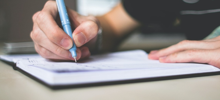 a person signing a paper