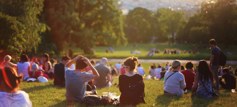 people sitting in the park after moving from NYC to Texas