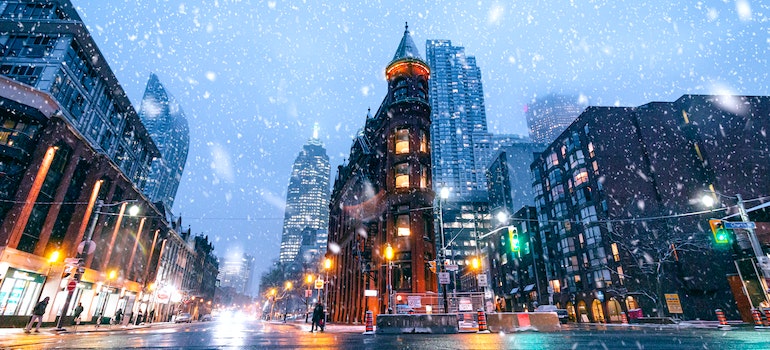snow falling on the street at dawn
