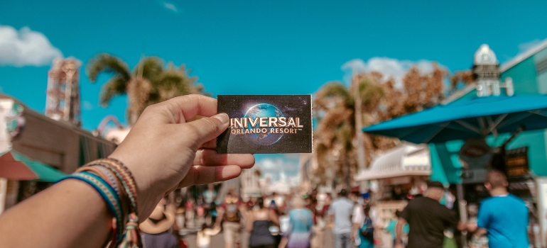 a person holding Universal Studios card