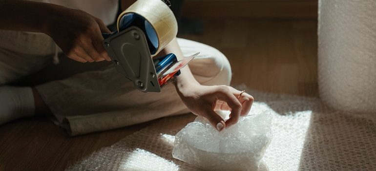 a person wrapping things in bubble wrap