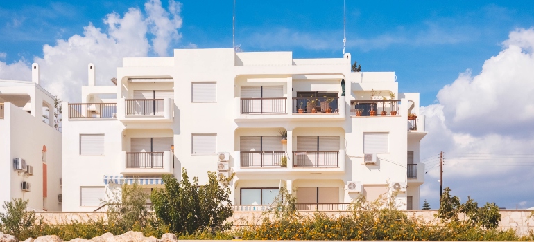 white three-story house 