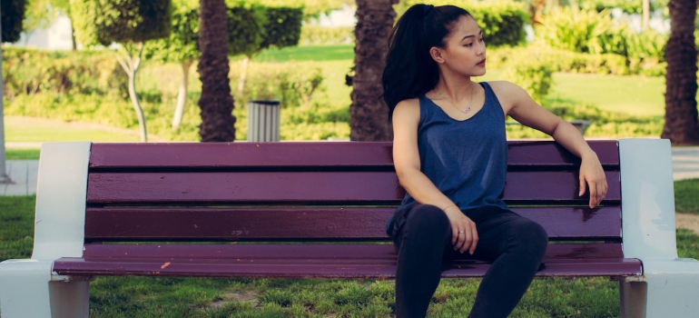 a woman sitting ont he bench thinking how to choose a good retirement location