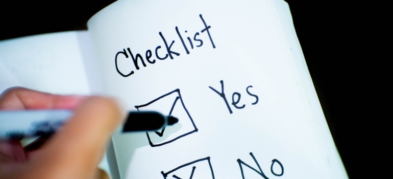 a person ticking a box on a checklist 