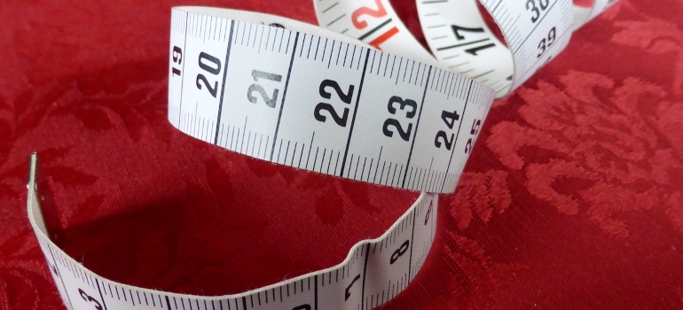 a measuring tape on a red surface