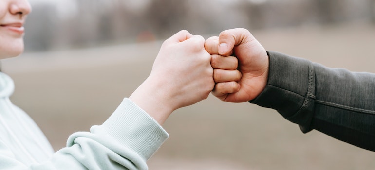 Friends fist-bumping