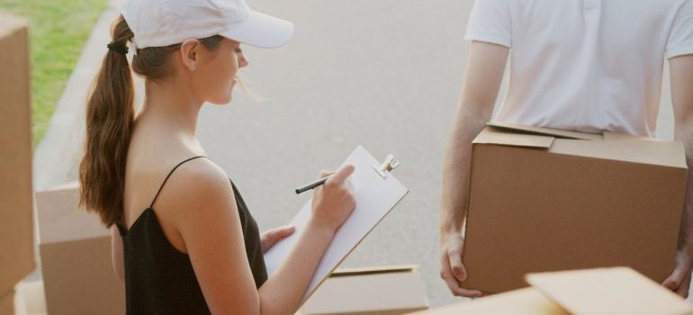 woman checking if all interstate moving rules and regulations are followed