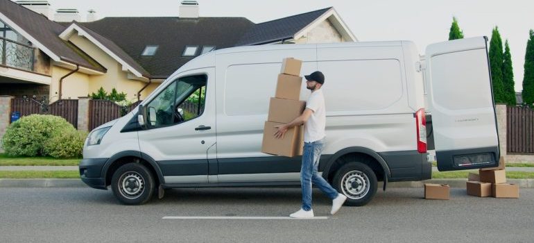 man carrying boxes