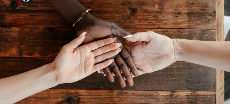 diverse women stacking hands