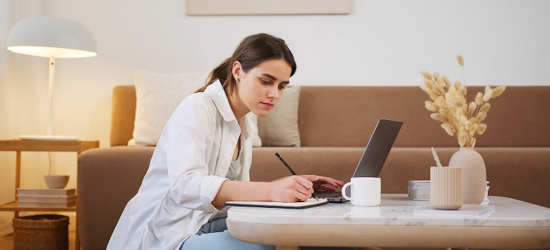 A young woman using a laptop for navigating the job market in NC