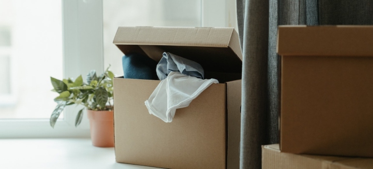 Picture of packed boxes next to a window 