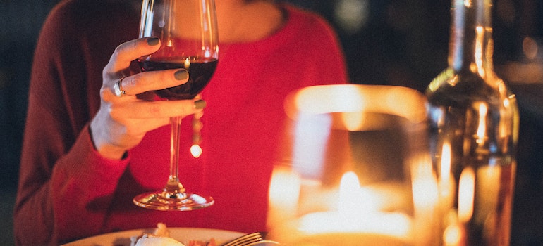 A woman is drinking wine and enjoying dinner is one of the fun things to do in Ocean City