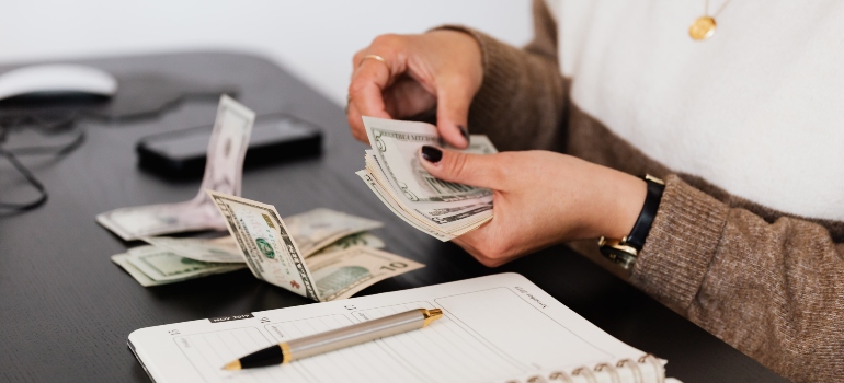 A woman counting money for living expenses