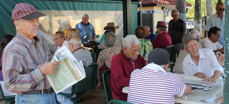 Men sitting at the table playing dominoes