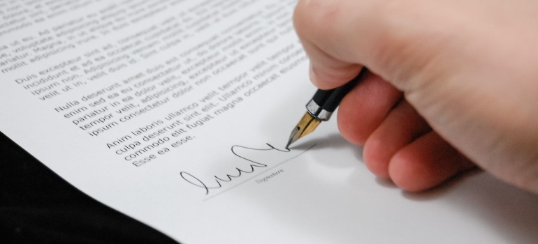 Picture of a person signing a contract 