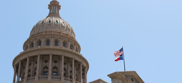 Capitolio del estado con la bandera de Texas.