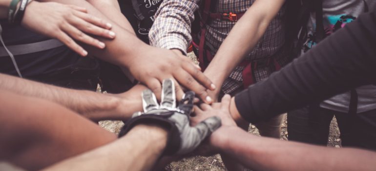 people doing group hand cheer