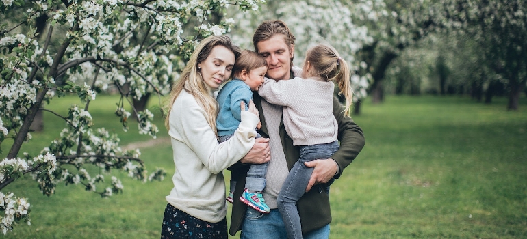 A happy family hugging outdoors