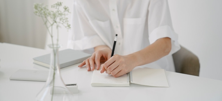 a person writing a list of things to Explore in Fresno After Your Move