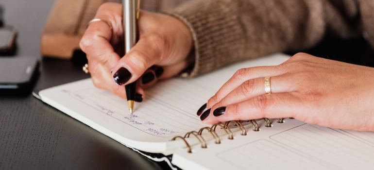 a woman writing how to pack and move your home gym equipment for an interstate move to Houston