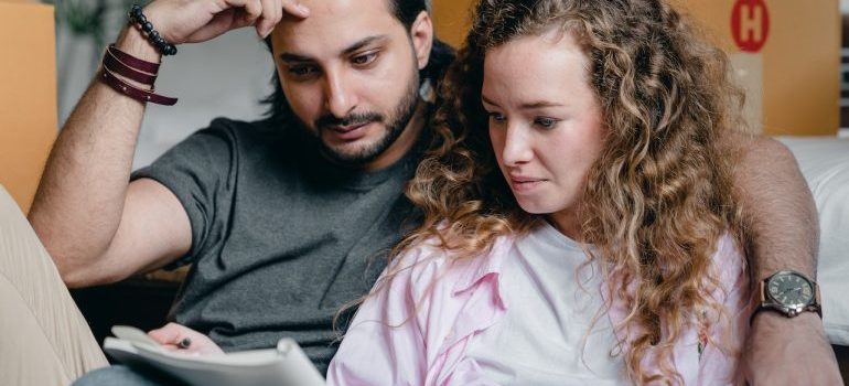 a couple reading about pros and cons of living in La Grange