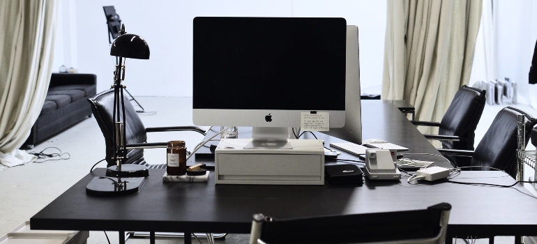 Apple computer on a black desk