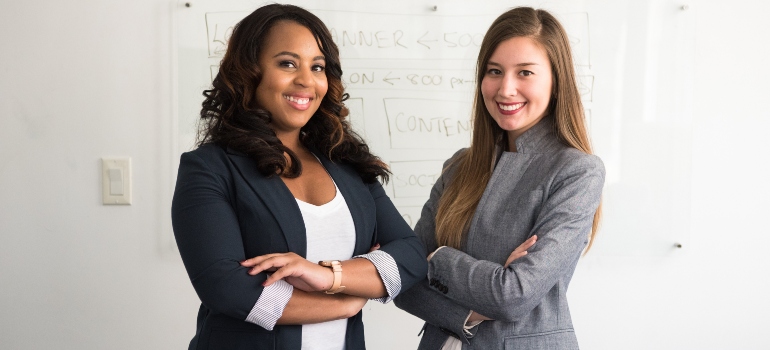 two business women discussing how to adjust after moving from New Braunfels to Long Island